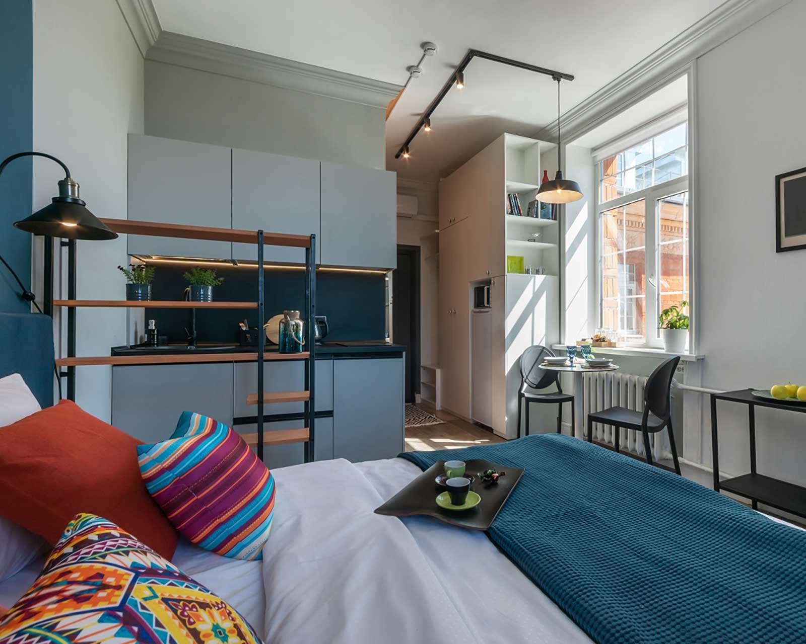Small condo interior with a bed and storage solutions