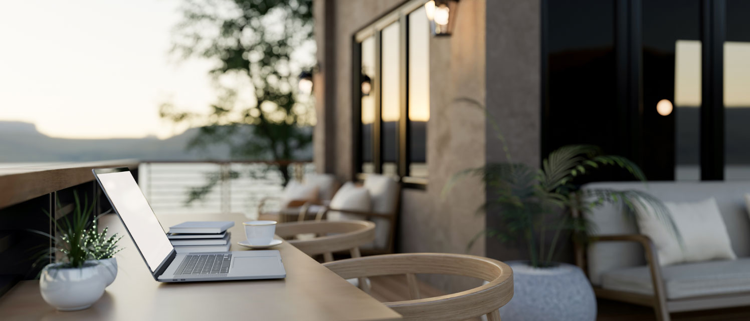 Cozy coffee shop balcony design with a laptop